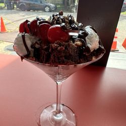 Milky Way Brownie Bar - Brownie sundae with cow tipping flavored ice cream, whipped cream, cherries, chopped pecans and hot fudge