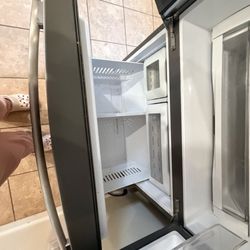 My GE profile not cooling on top fridge , but freezer works .
