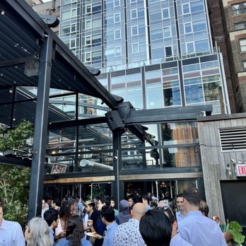VERSA - a crowd of people standing outside of a building - New American Near Me - New York, New York