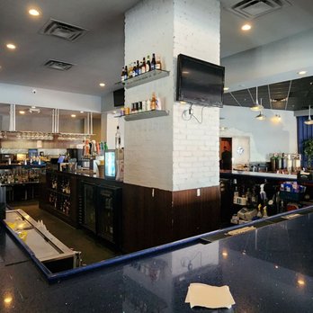 Funny Bone Comedy Club & Restaurant - a man sitting at the bar - Comedy Clubs Near Me - Orlando, Florida Funny Bone Comedy Club & Restaurant - a man sitting at the bar - Comedy Clubs Near Me - Orlando, Florida
