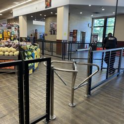 Safeway - Metal fencing with two armed guards. One at the front and the other one on patrol around the store.