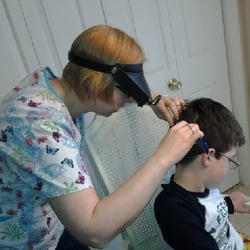 LiceDoctors - Monmouth County - LiceDoctors technician checks for lice and nits (eggs) in her client's hair.