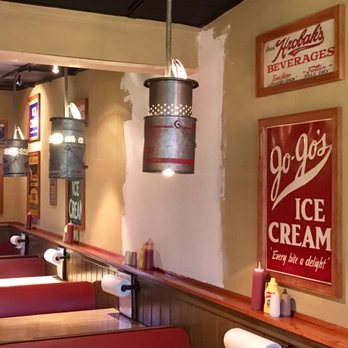 Gilligan's Island - The seating area inside with some of the old-school metal signs decorating the walls. Love the bait buckets repurposed for lighting! - Burgers Near Me - Sherburne, New York Gilligan's Island - The seating area inside with some of the old-school metal signs decorating the walls. Love the bait buckets repurposed for lighting! - Burgers Near Me - Sherburne, New York