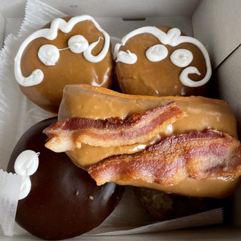 Voodoo Doughnut - Top: maple cream Middle: maple bacon Left bottom: chocolate cream Hidden: blueberry - Donuts Near Me - Denver, Colorado Voodoo Doughnut - Top: maple cream Middle: maple bacon Left bottom: chocolate cream Hidden: blueberry - Donuts Near Me - Denver, Colorado