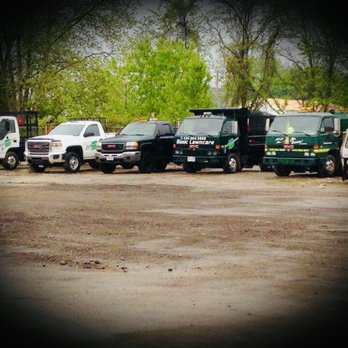 Basic Lawncare - a group of trucks parked in a lot - Lawn Services Near Me