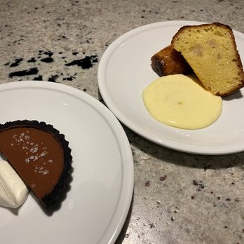 Benzina - R: Chocolate Tarte w/ salted caramel and Chantilly cream. L: Babá soaked in Limoncello with D'Anjou Pears, vanilla diplomat, and lemon curd. - Italian Near Me - Denver, Colorado Benzina - R: Chocolate Tarte w/ salted caramel and Chantilly cream. L: Babá soaked in Limoncello with D'Anjou Pears, vanilla diplomat, and lemon curd. - Italian Near Me - Denver, Colorado