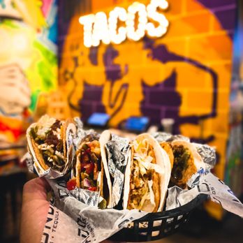 Condado Tacos - a hand holding a taco - Tacos Near Me - Carmel, Indiana Condado Tacos - a hand holding a taco - Tacos Near Me - Carmel, Indiana