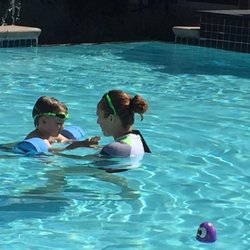Sunsational Swim School - At-Home Swim Lessons - 3 Year old student learning how to kick with a barbell