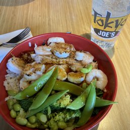 a bowl of shrimp, broccoli, and snow peas