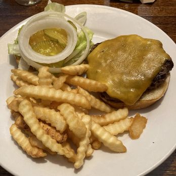 Bubb's Grub - Cheeseburger - A cheeseburger with melted cheese on a beef patty, served with crinkle-cut fries and a side salad of lettuce, onion, and pickle slices. - Barbeque Near Me - Catalina, Arizona