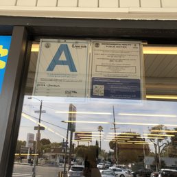 a sign in the window of a convenience store a sign in the window of a convenience store