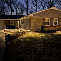 Grounds Pros - After photo a recent renovation. New walkway, sod, lighting, paver patio and sitting wall.
