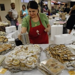 Melkite Rite Food and Cultural Festival - Volunteer sprinkle sugar over pastries.