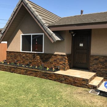 Unity Construction - Stacked stone and travertine tile steps with lights. - General Contractors Near Me