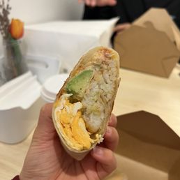 Breakfast burrito - small bit of avocado and tons of eggs and soft potatoes Breakfast burrito - small bit of avocado and tons of eggs and soft potatoes