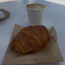 Oatmeal, cappuccino, and ham and cheese croissant.