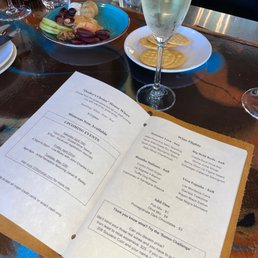 Menu with vegetarian snack board and los monteros cava
