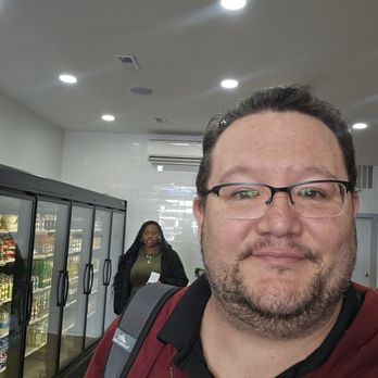 Burger Urway - a man standing in front of a refrigerator - Burgers Near Me - Brooklyn, New York