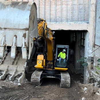 ACD QUALITY - a construction worker standing in front of an excavator - General Contractors Near Me