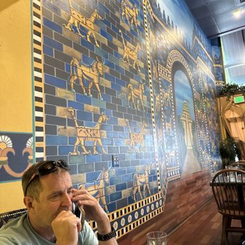 DarSalam - It's a picture of my husband in front of the wall of Babylon - Middle Eastern Near Me - Portland, Oregon