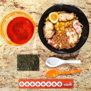 Sushi Monsta - Tan Tan Men ramen noodles with pork before assembly. The reddish broth is on the left. Dried seaweed is the black rectangle. - Sushi Bars Near Me - Suitland, Maryland