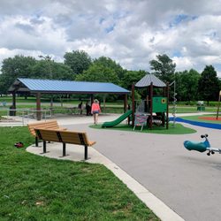 Seating and picnic tables with toddler playground.