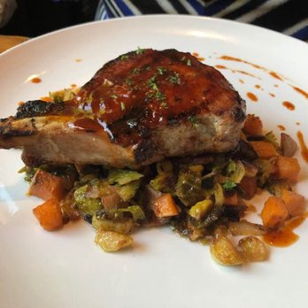 FlatIron Kitchen & Taphouse - Grilled porkchop and braised veggies - New American Near Me - Davidson, North Carolina