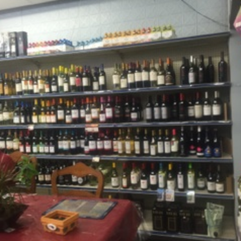Resendes Market - a woman sitting at a table in a wine shop - Beer, Wine & Spirits Near Me - Braintree, Massachusetts Resendes Market - a woman sitting at a table in a wine shop - Beer, Wine & Spirits Near Me - Braintree, Massachusetts