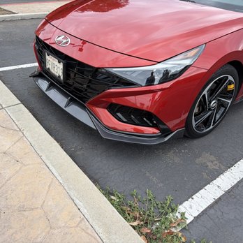 Touch Up Specialist - The lower corner nearest the camera was repaired and looks like new, and you can see the front bumper spoiler that he installed as well. - Body Shops Near Me