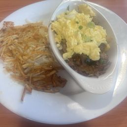 Carnitas  with scrambled eggs and hash browns.