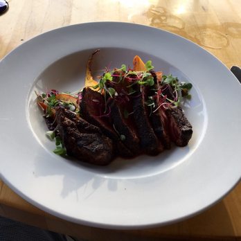 Firefly Grill - Espresso rubbed NY strip special with glazed carrots, peaches and a merlot sauce. Perfectly medium rare - Steakhouses Near Me - Effingham, Illinois
