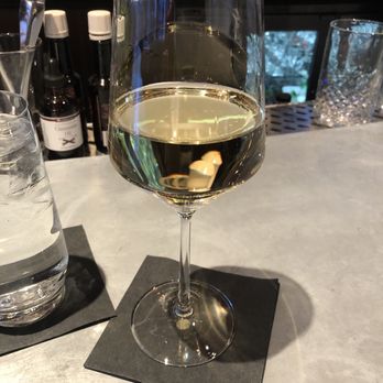 Zephyr Bar - Glass of chardonnay at the bar - Cocktail Bars Near Me - Seattle, Washington Zephyr Bar - Glass of chardonnay at the bar - Cocktail Bars Near Me - Seattle, Washington
