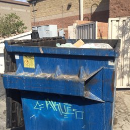 Taken from my car. This is just out the window. I'm not sure why they don't put the dumpster inside the little walled off area.