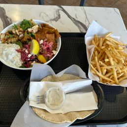 Chicken bowl and seasoned fries. Complimentary pita Chicken bowl and seasoned fries. Complimentary pita