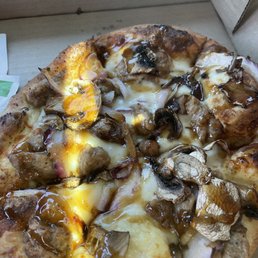 Iron pizza. Sausage with bourbon glazed onions and mushrooms on a garlic sauce. Perfect crust and balance of flavors Iron pizza. Sausage with bourbon glazed onions and mushrooms on a garlic sauce. Perfect crust and balance of flavors