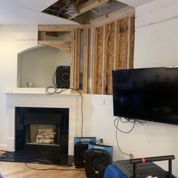 247 Aquadry - a living room with a fireplace and a flat screen tv - Damage Restoration Near Me - Waxhaw, North Carolina