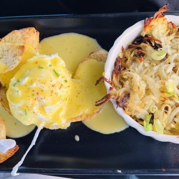 The Cottage - Poached eggs with croissant and covered with hollandaise sauce with the side of shoestring hash browns - Cocktail Bars Near Me - Bothell, Washington