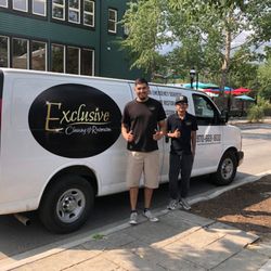 Exclusive Cleaning and Restoration - Two of our expert technicians smile after completing a carpet cleaning job on Main Street in Breckenridge.