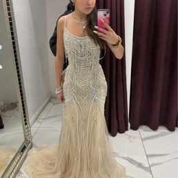 Before the alterations  The dress looks fitted because it was being held behind