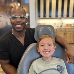 Children's Dentistry - Dr. Adam Hine smiling with a patient at Children's Dentistry of Utah