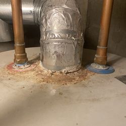 AC&E Home Inspection - Top of hot water heater where vent was sealed over.