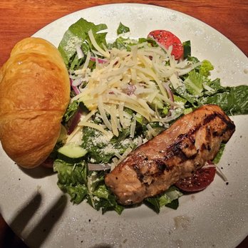 Charleston's - Salmon Caesar salad and the buttered croissant that comes with the entree. - American Near Me - Omaha, Nebraska