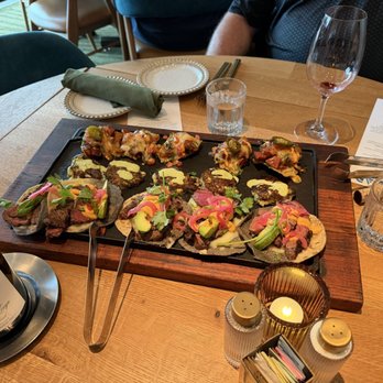 VERDAD True Modern Mexican - Appetizer platter...beef fajitas, corn and octopus fritters, and sausage and pepper nachos - Mexican Near Me - Austin, Texas VERDAD True Modern Mexican - Appetizer platter...beef fajitas, corn and octopus fritters, and sausage and pepper nachos - Mexican Near Me - Austin, Texas