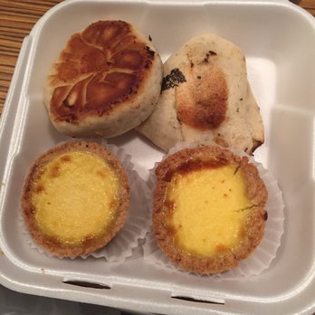 Tofu 101 - Egg tarts on the bottom and the pan fried buns on top. The left/round one is the veggie shrimp, and the right/triangle one is the pork. - Chinese Near Me - Bellevue, Washington Tofu 101 - Egg tarts on the bottom and the pan fried buns on top. The left/round one is the veggie shrimp, and the right/triangle one is the pork. - Chinese Near Me - Bellevue, Washington