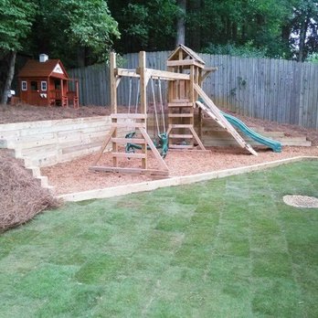 Cherokee Tree & Landscape - New backyard with play set assembled. New sod, retaining wall - Landscaping Near Me - Woodstock, Georgia Cherokee Tree & Landscape - New backyard with play set assembled. New sod, retaining wall - Landscaping Near Me - Woodstock, Georgia