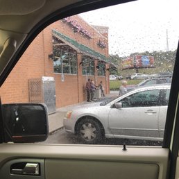 a man washing his car in the rain a man washing his car in the rain