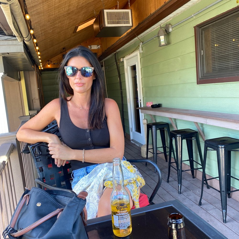 Kuepers Tavern - a woman sitting at a table with a beer - Pubs Near Me - Dickeyville, Wisconsin Kuepers Tavern - a woman sitting at a table with a beer - Pubs Near Me - Dickeyville, Wisconsin