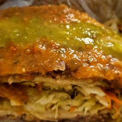 Pupuseria Salvadorena - Marinated cabbage between 2 halves of my PBC Pupusa topped w red/green sauce