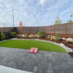 Clean and simple backyard. Artificial grass with patio. Palm trees, mountain hemlock, various shrubs. Clean and simple backyard. Artificial grass with patio. Palm trees, mountain hemlock, various shrubs.