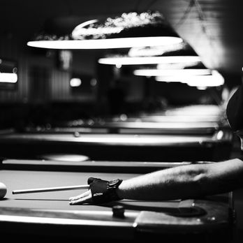 Empire Pubcade & Venue - a man playing pool - Sports Bars Near Me - Lawrence, Kansas